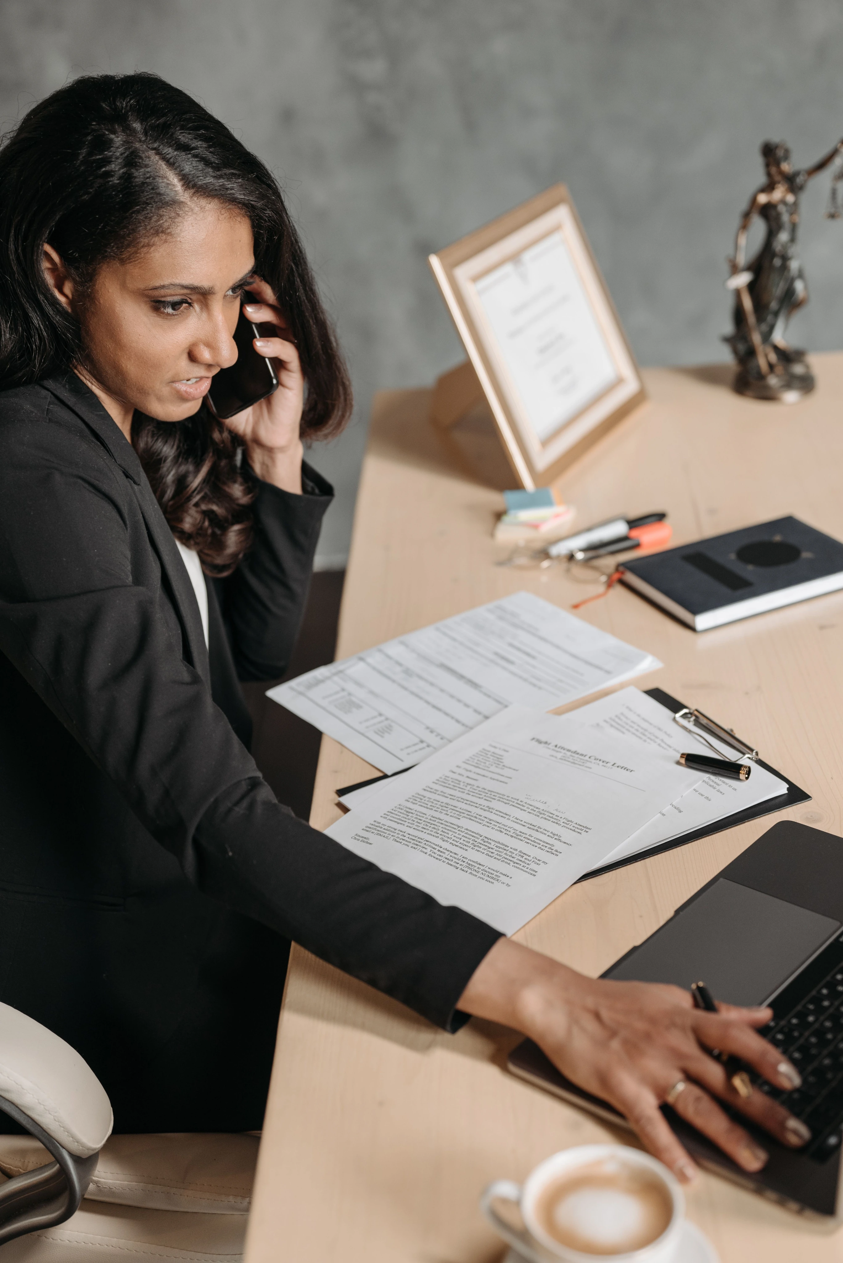 Lawyer at office desk on phone